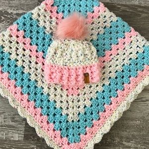 Handmade crocheted baby blanket with matching infant hat.